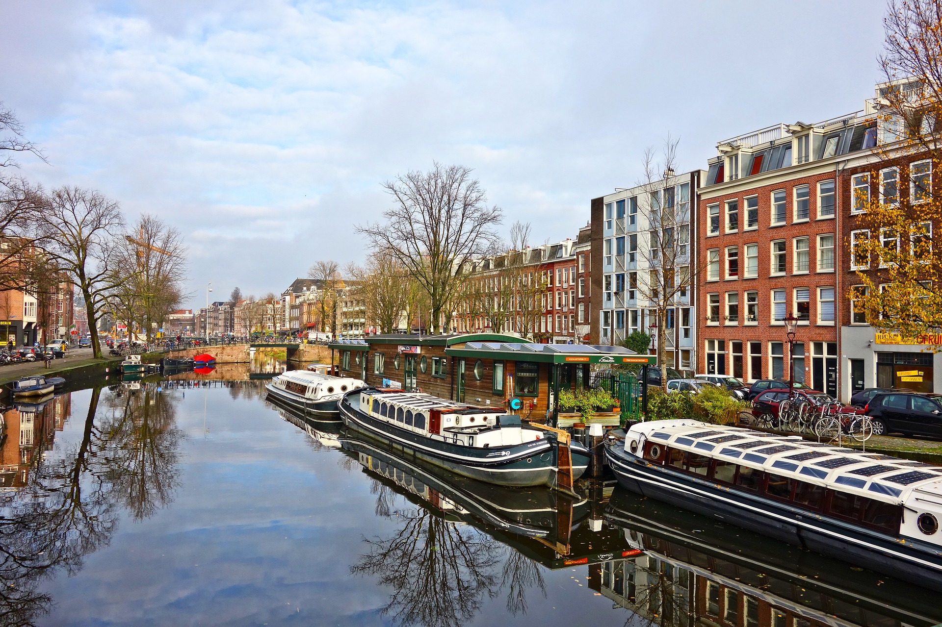 boats on a canal with buildings in the background