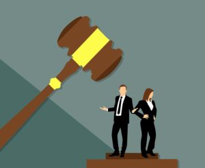 a man and woman standing on a podium with a gavel