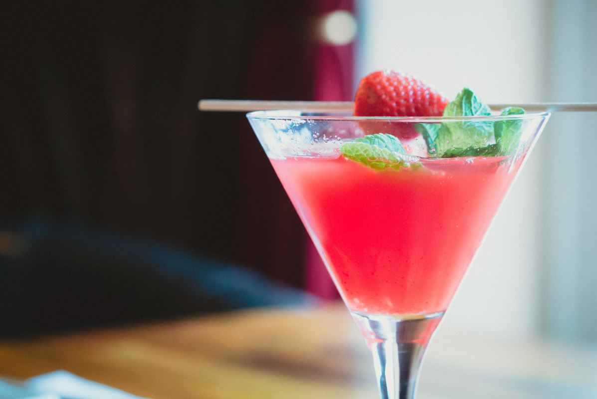 a glass with a drink and a strawberry on it