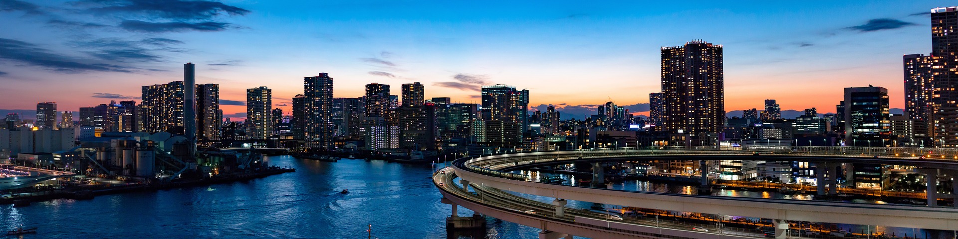 a city skyline with a bridge over water