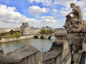 a statue on a bridge over a river