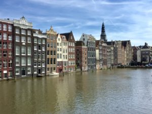 a row of buildings next to a body of water