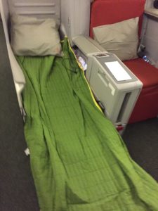 a green blanket on a bed