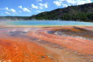a hot spring with orange and blue water