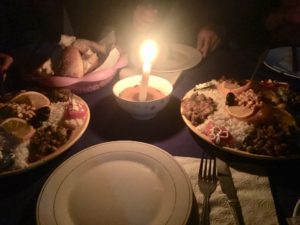 a plate with food on it and a candle in the middle
