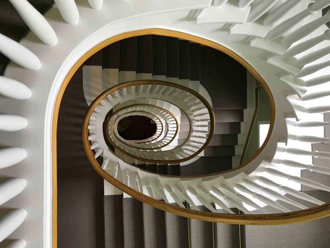 a spiral staircase with white and brown stairs