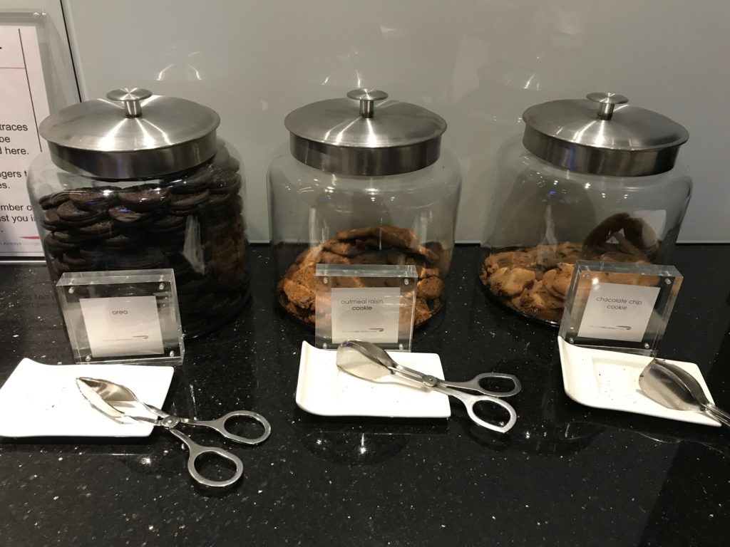 a group of jars with cookies and scissors