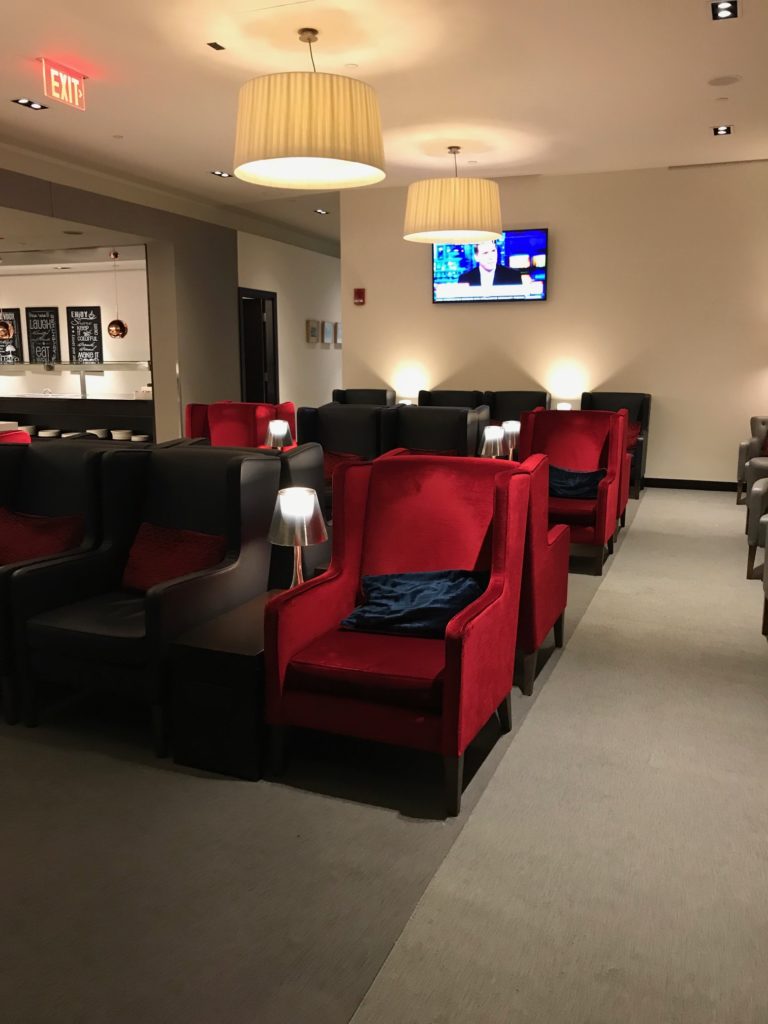 a room with red chairs and a television