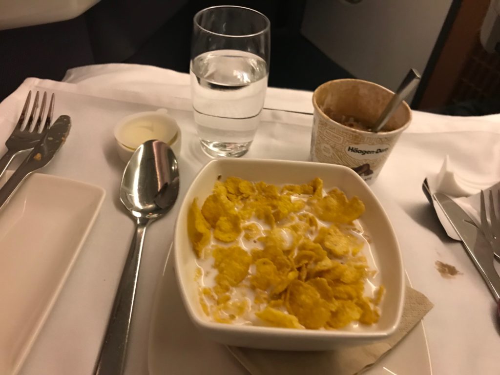a bowl of cereal and milk on a table