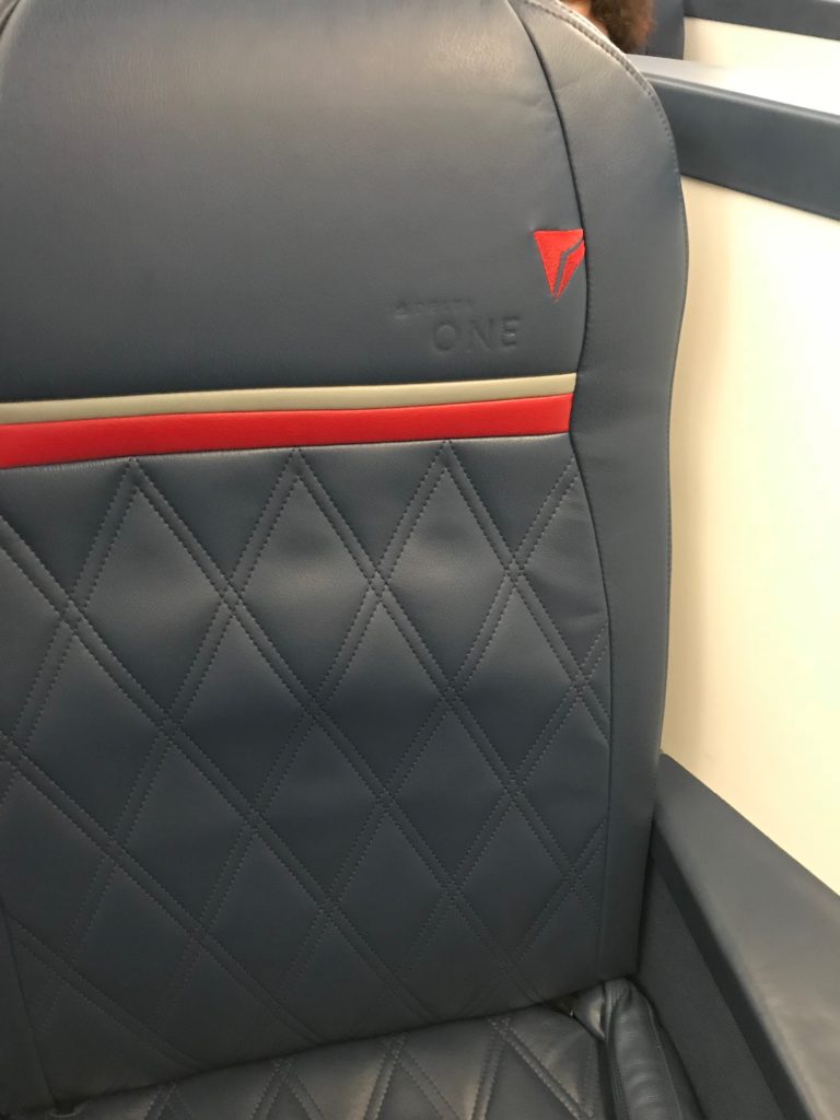 a seat with a red and white logo