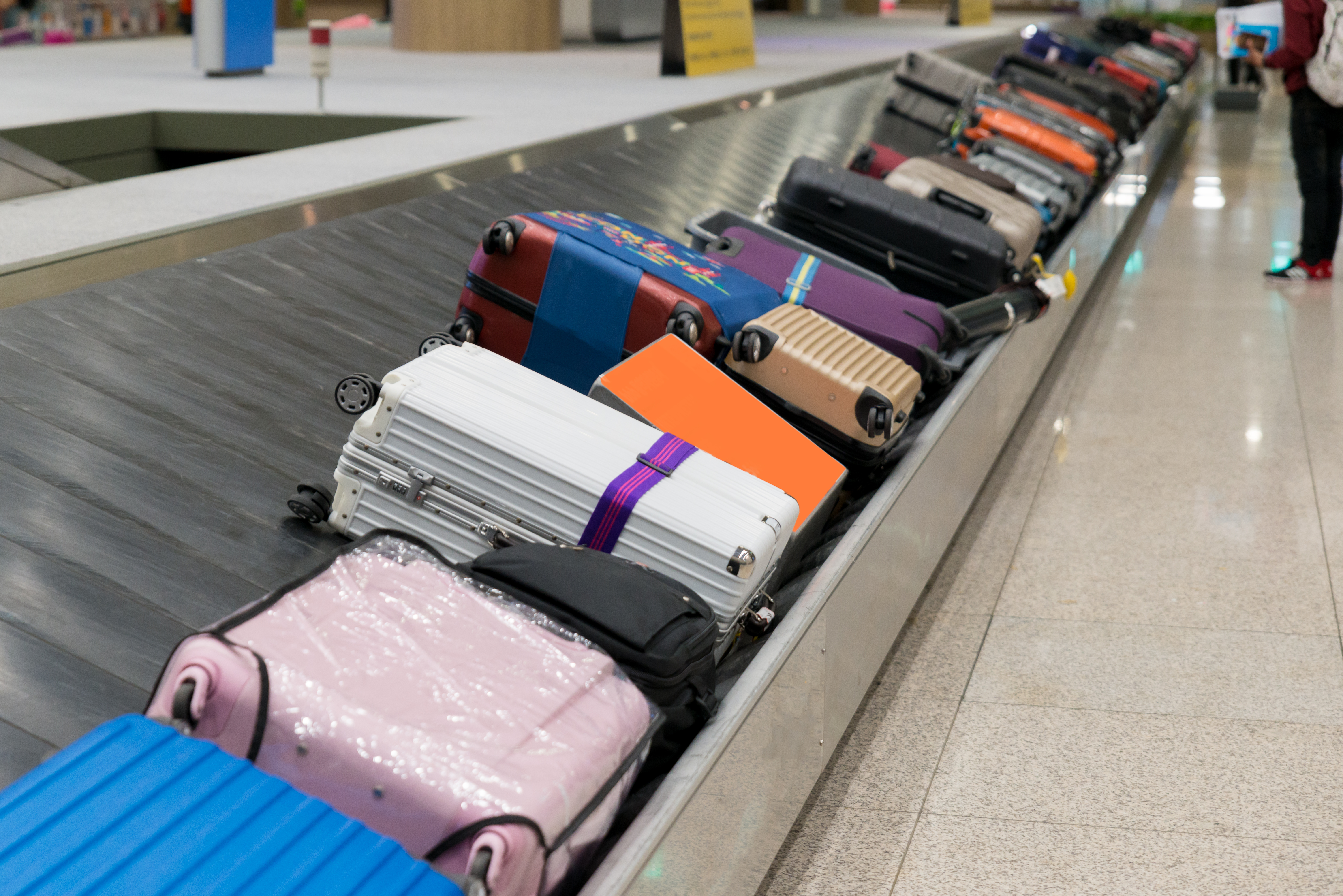 a group of luggage on a conveyor belt