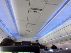 a ceiling with lights and a person sitting in the back