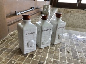 a group of white bottles on a tile surface