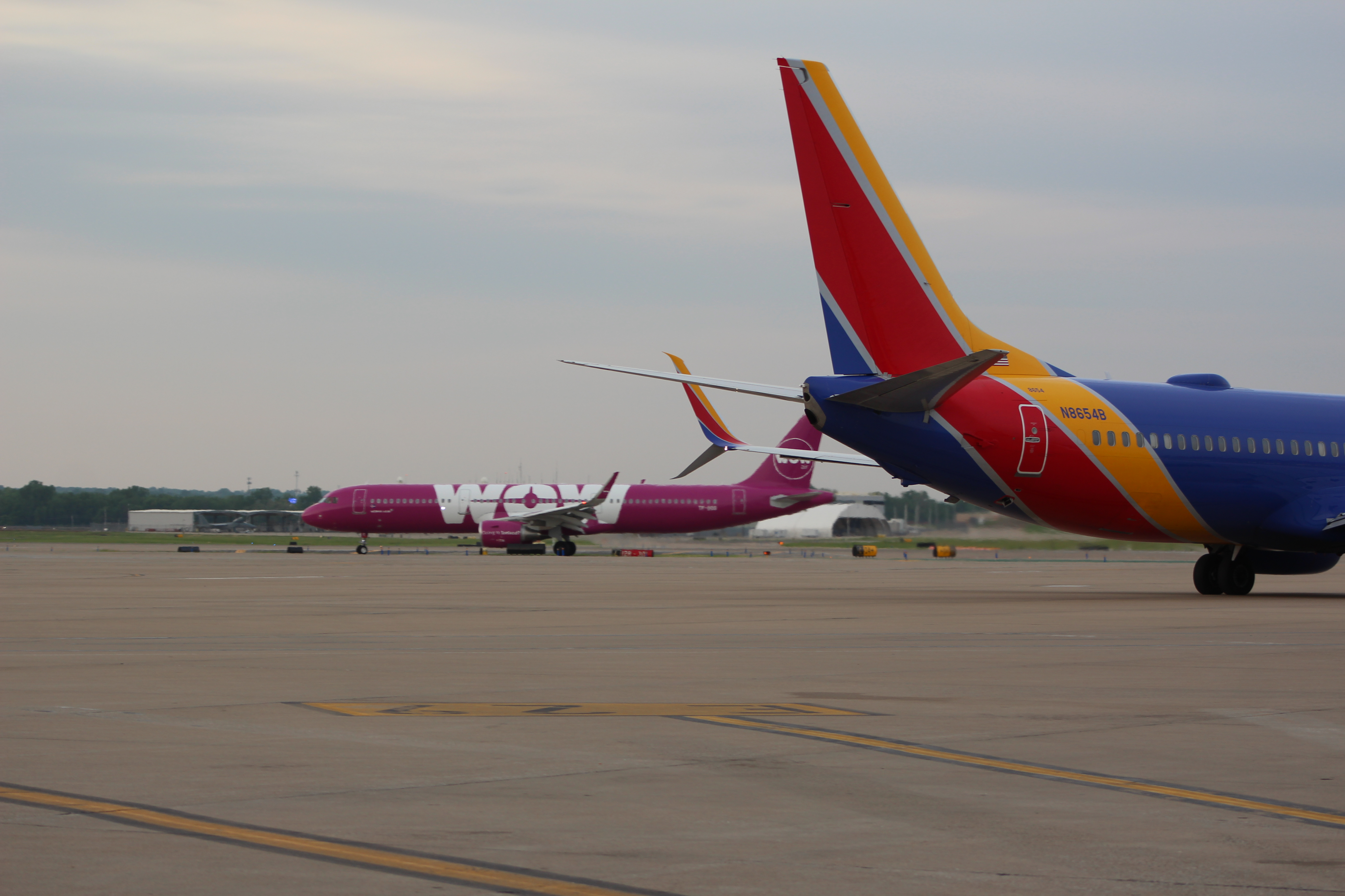A Southwest Airlines 737 Passes In-Front Of The First WOWAir Arriving Flight