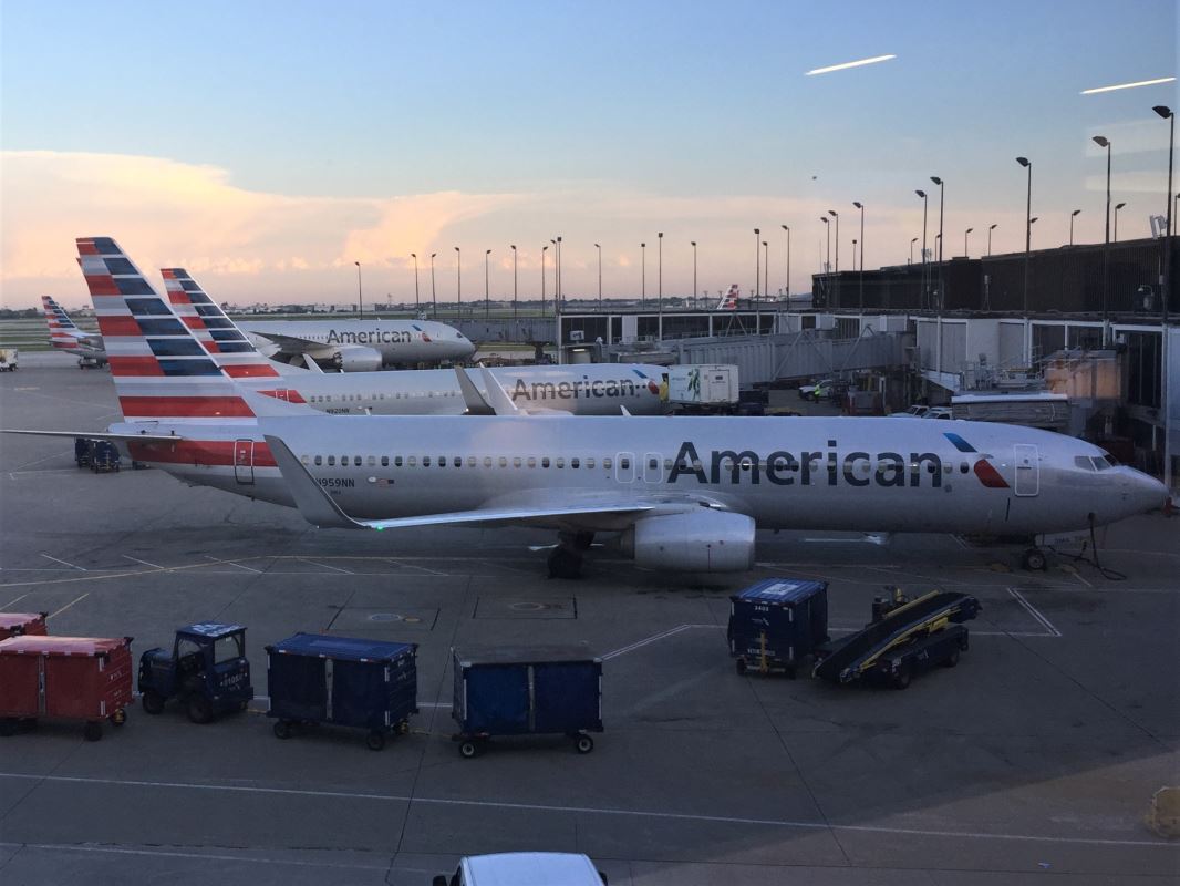 a group of airplanes at an airport