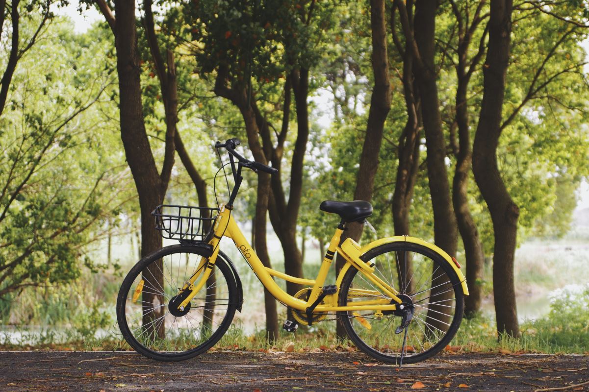 a yellow bicycle with a basket on the front