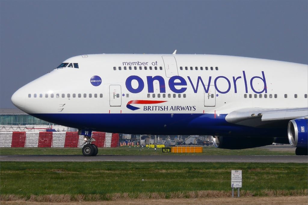 a large white and blue airplane on a runway