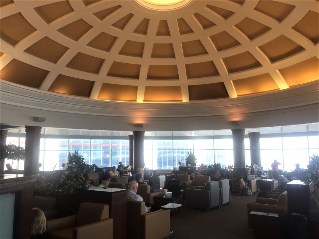 a group of people sitting in a room with a dome ceiling