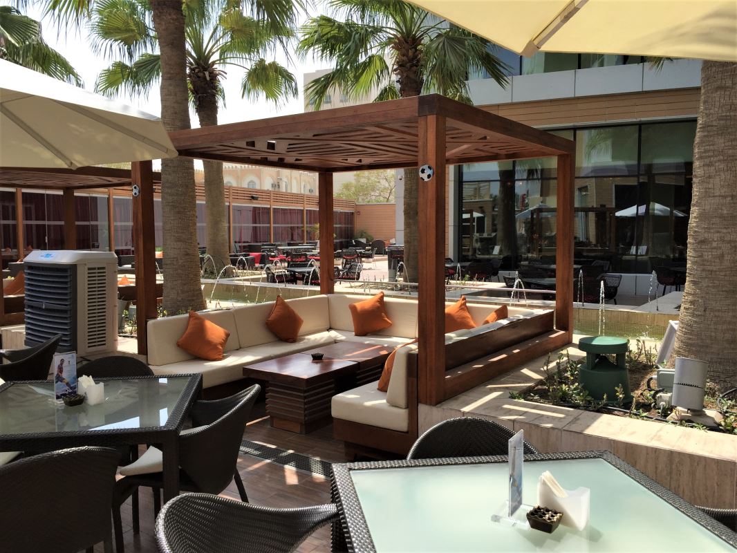 a patio area with tables and chairs