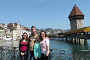 a group of people posing for a picture with Kapellbrücke in the background