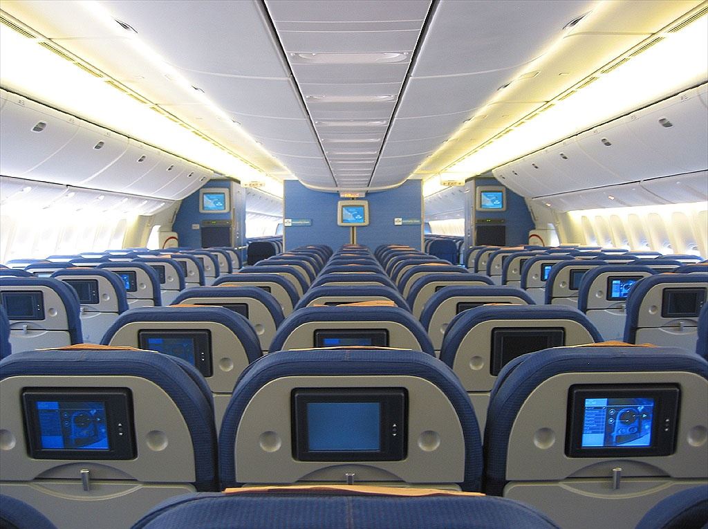 an airplane with rows of seats and monitors