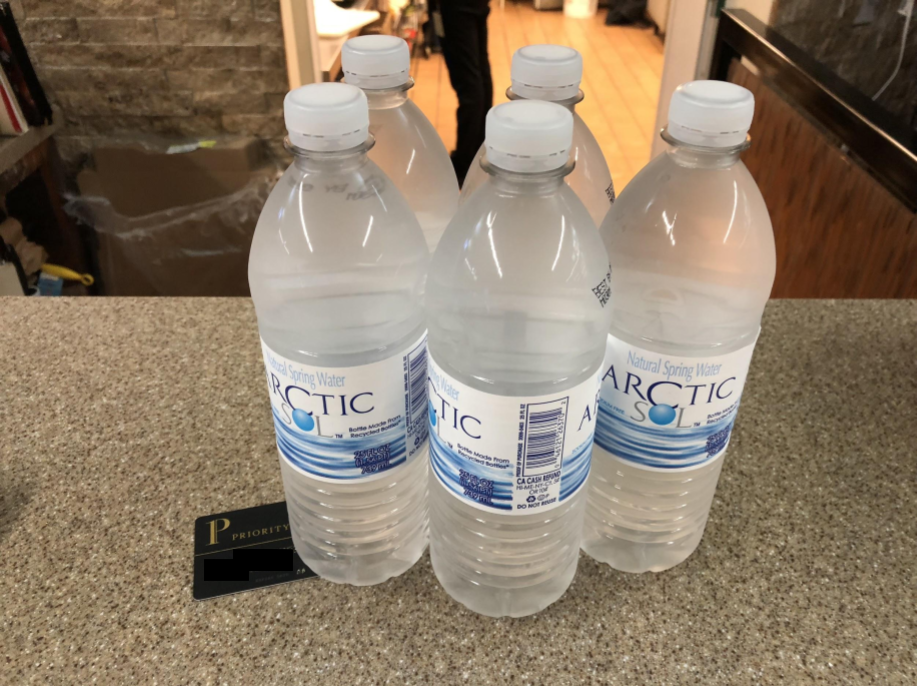 a group of water bottles on a counter