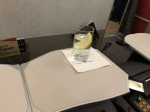 a glass of water with a lemon on a table