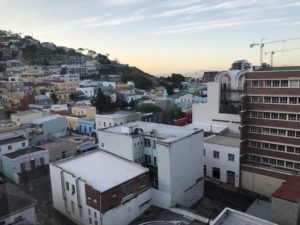 a city with buildings and a hill