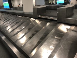 a metal luggage belt at an airport