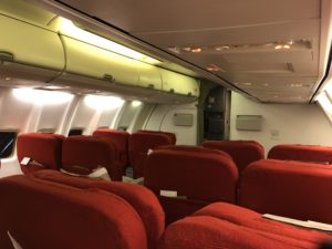 a row of red seats in an airplane