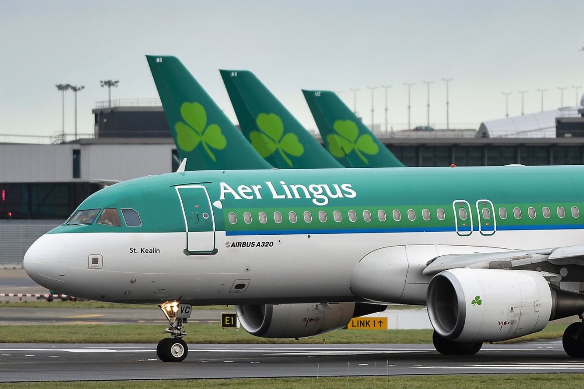 a green and white airplane on a runway