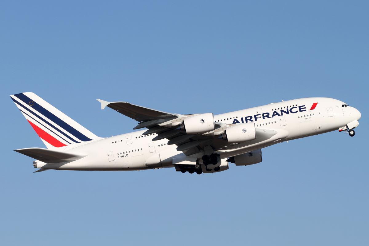 a large white airplane flying in the sky