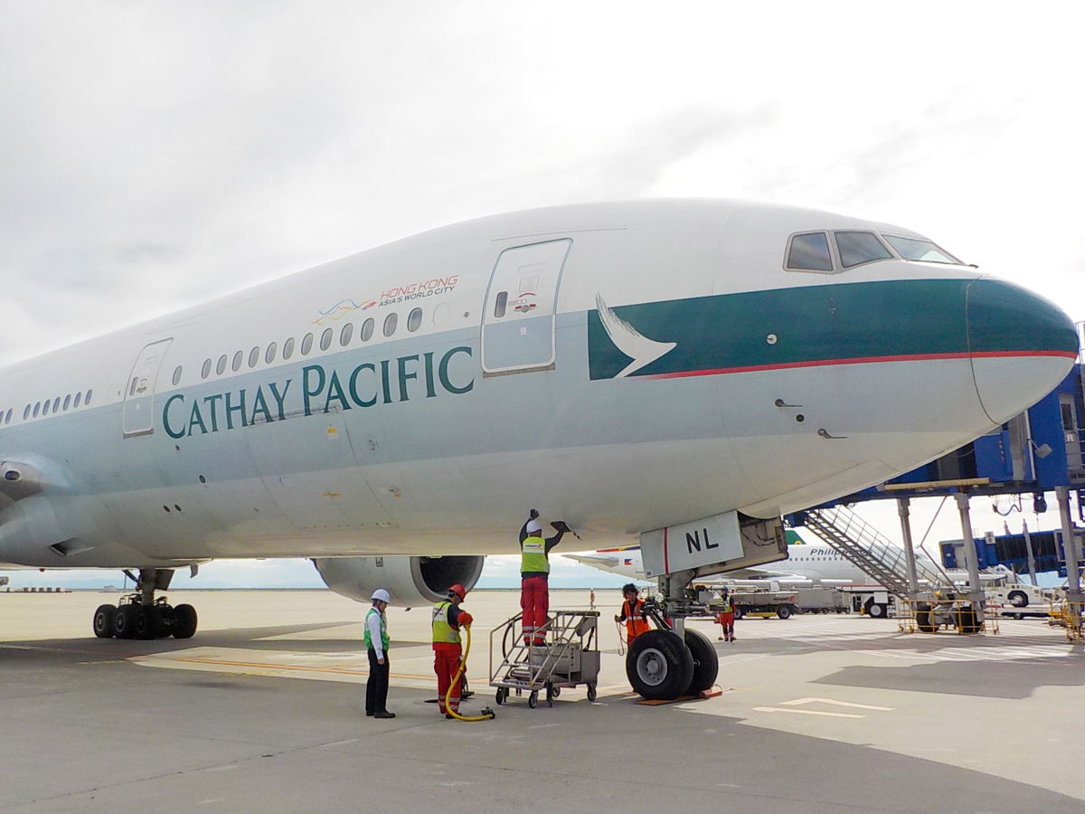 a group of people standing next to a large airplane