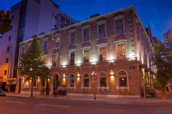 a building with lights on the side of the street