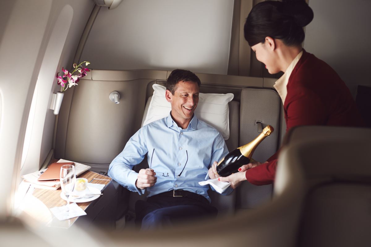 a woman giving a champagne to a man in a chair