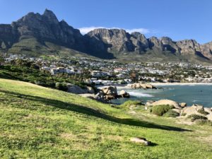 a landscape with a body of water and a city