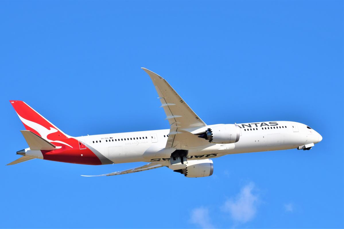 a white airplane flying in the sky