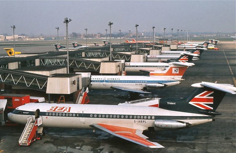 a group of airplanes parked at an airport