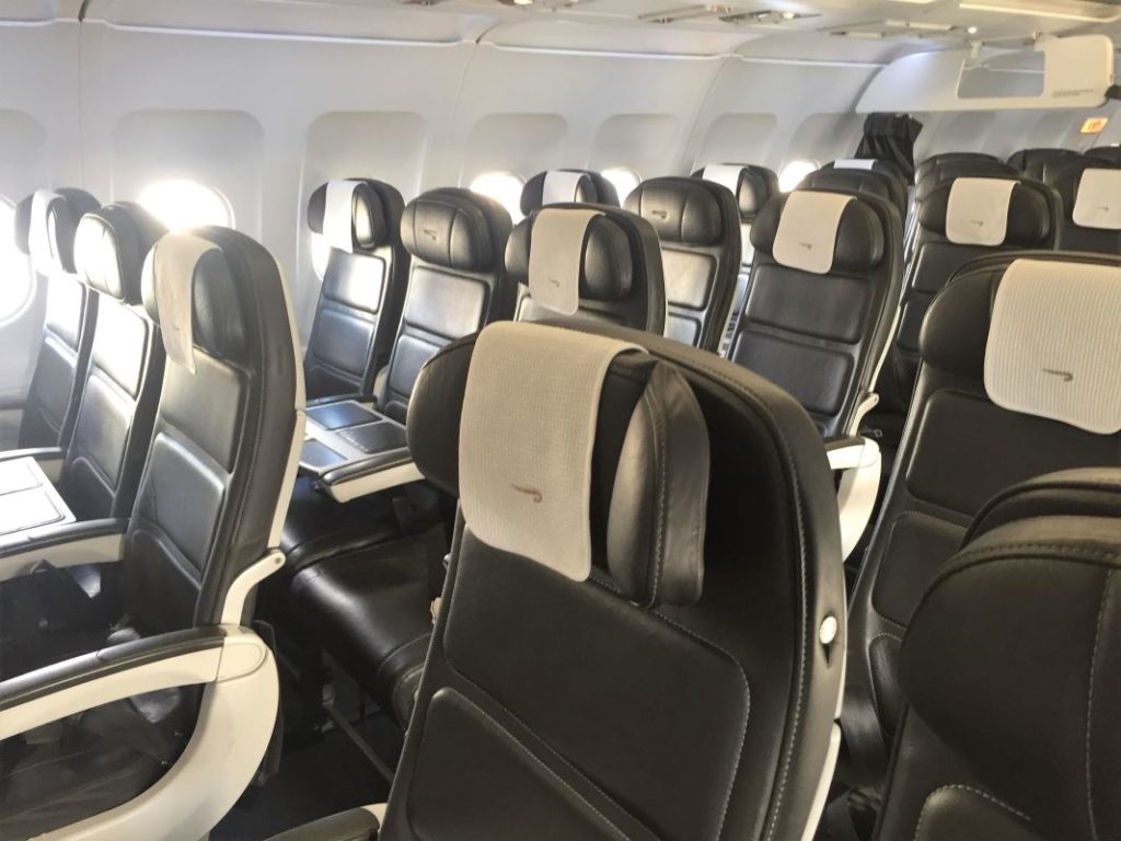 a row of black and white seats in an airplane