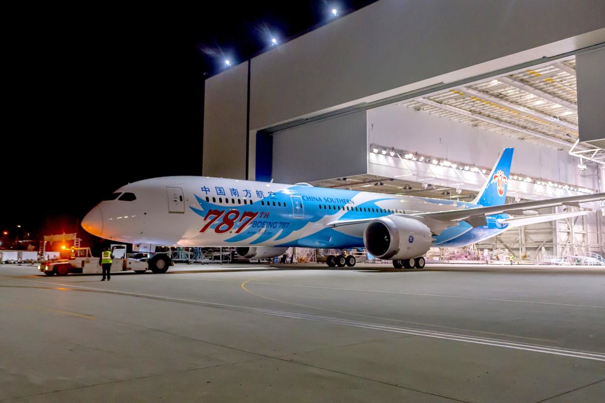 a blue and white airplane in a hangar