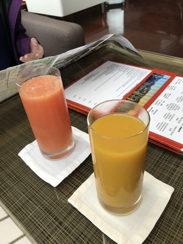 a couple of glasses of juice on a table