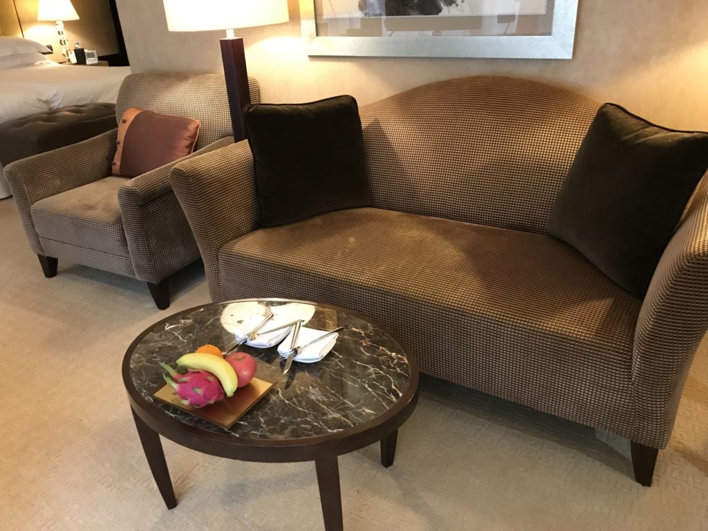 a couch with a tray of food on it