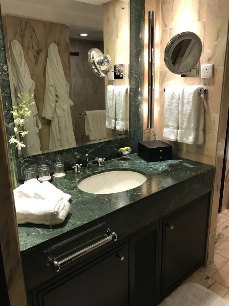 a bathroom with a mirror and towels