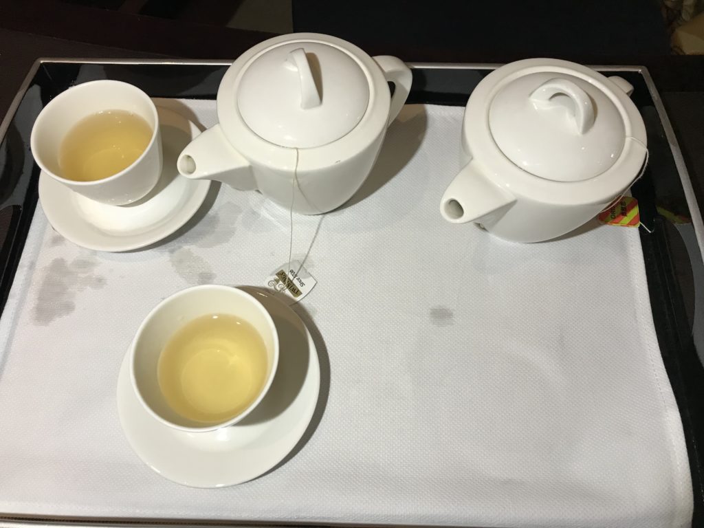 a tea set with teapot and cups on a tray