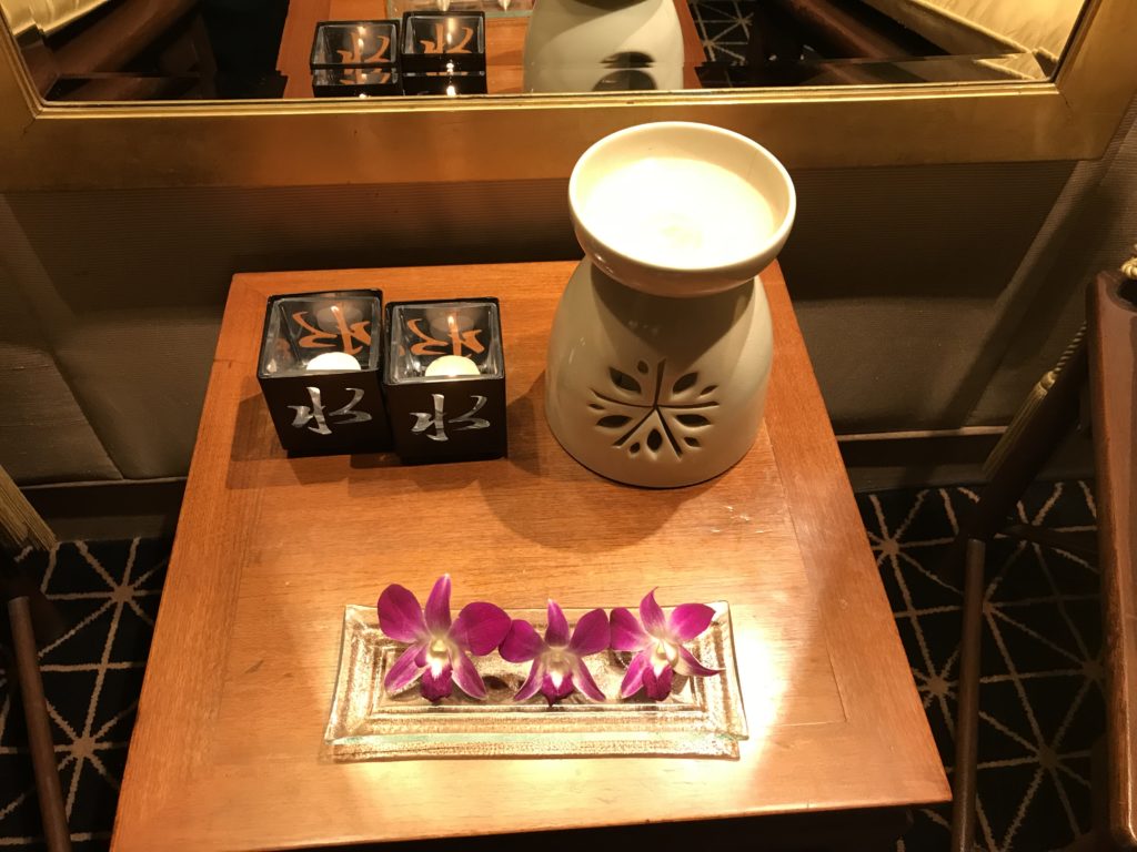 a candle holder and flowers on a table