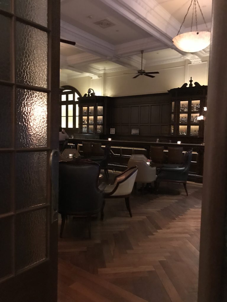 a room with a bar and chairs