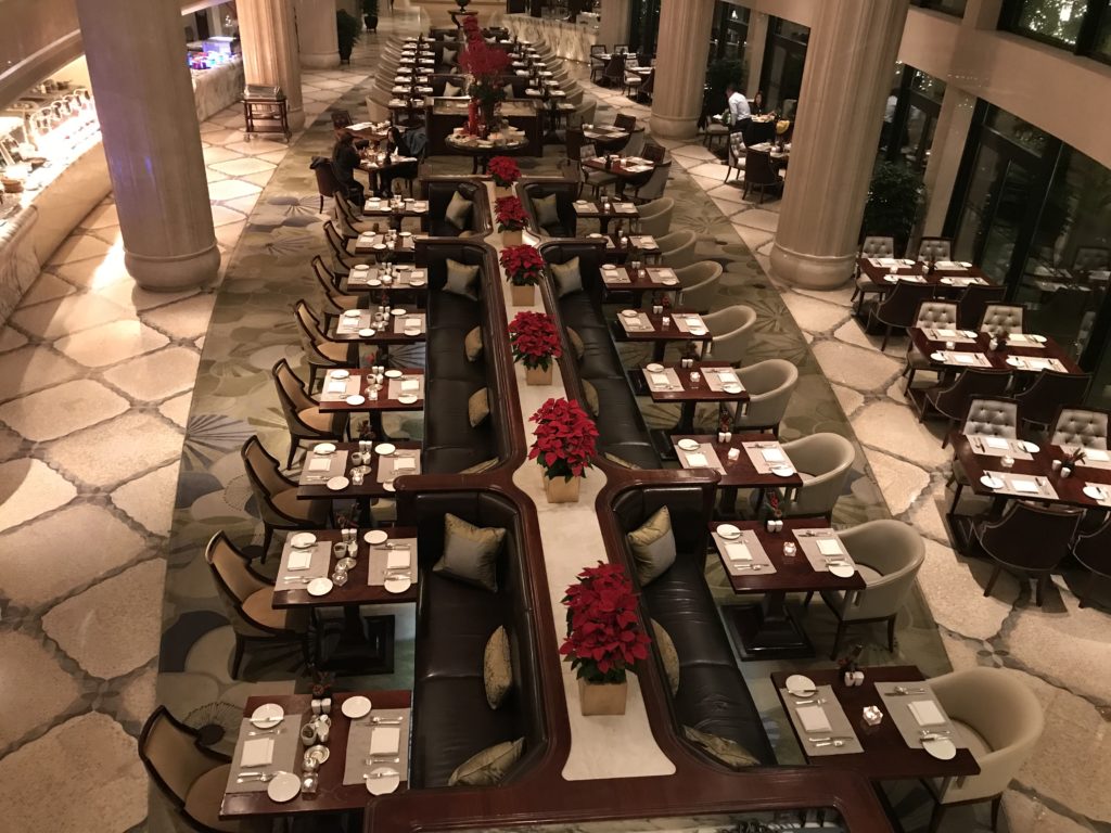a long table with chairs and tables in a restaurant