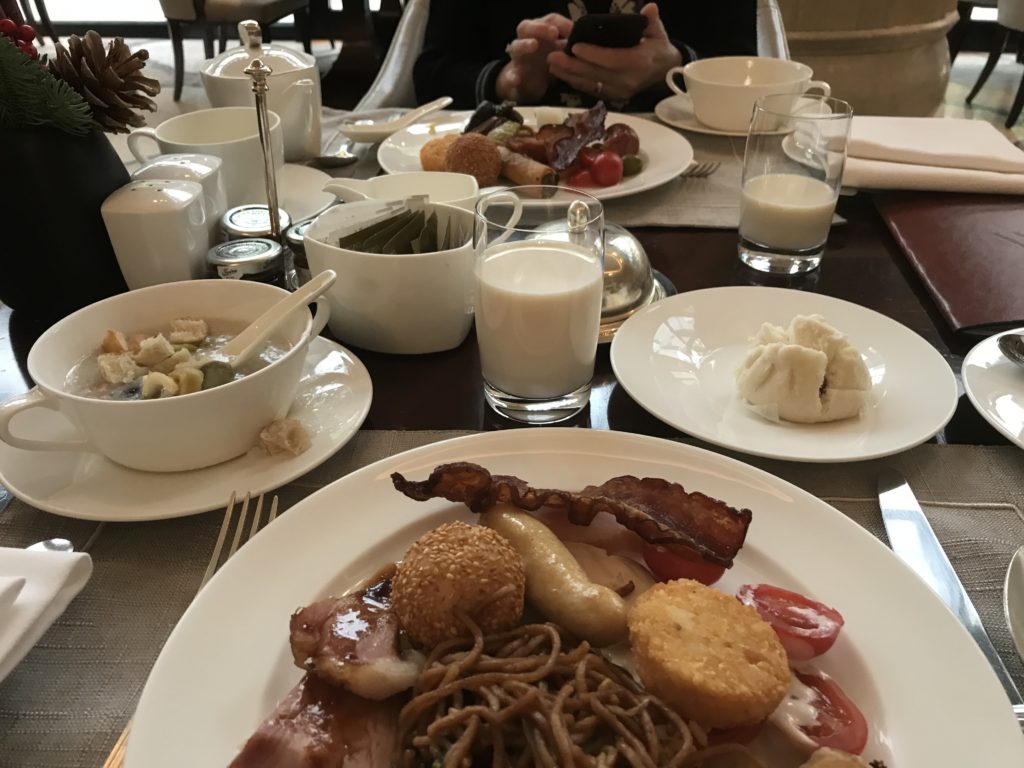 a table with plates of food and glasses of milk