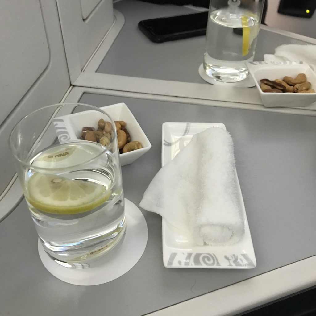 a glass of water and a napkin on a table