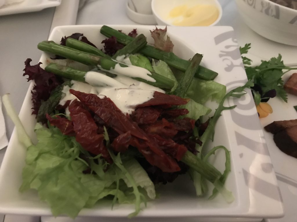 a plate of salad with sauce